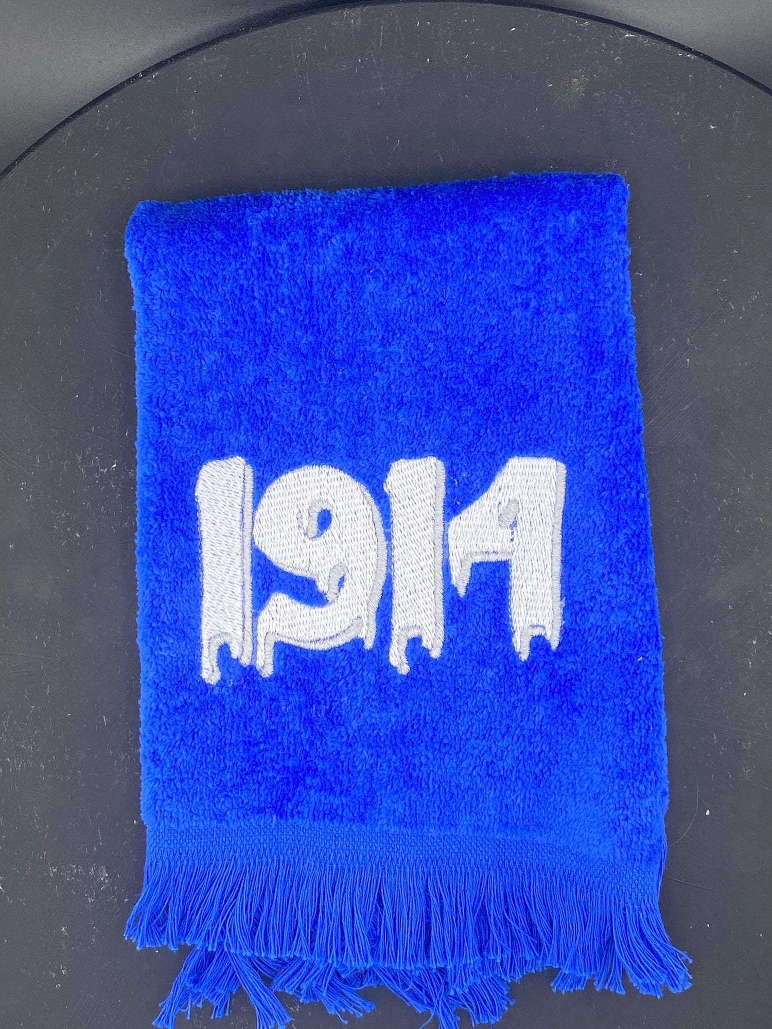 Royal Blue plush velour towel embroidered with a dripping 1914 in White with silver accent.