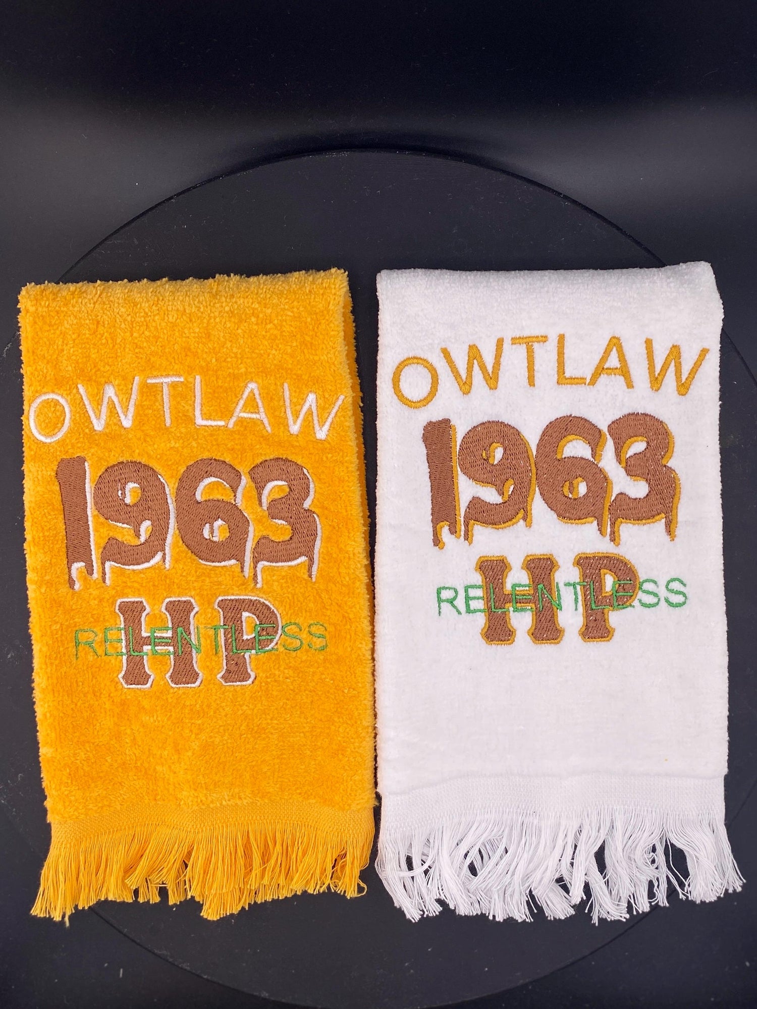 2 velour towels in gold and white, both embroidered with a dripping 1963 to represent Iota Phi Theta.