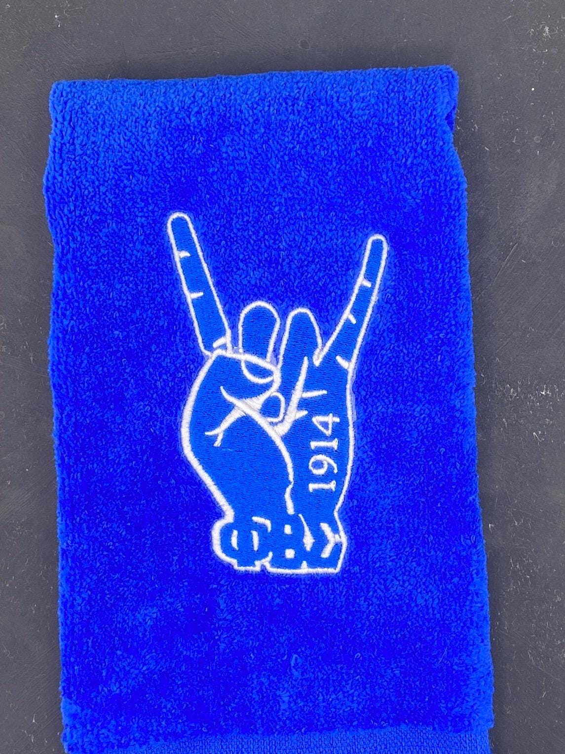 Phi Beta Sigma Hand Symbol embroidered on a royal blue velour fingertip towel. The design also features the greek letters and 1914. 