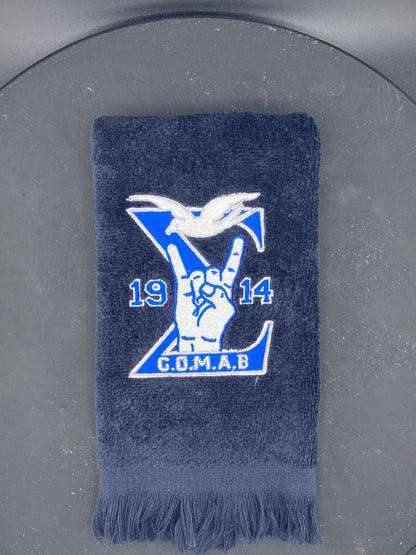 Black Stroll Towel with a Sigma, 1914, handsign, dove and GOMAB embroidered in royal blue, while and silver. 