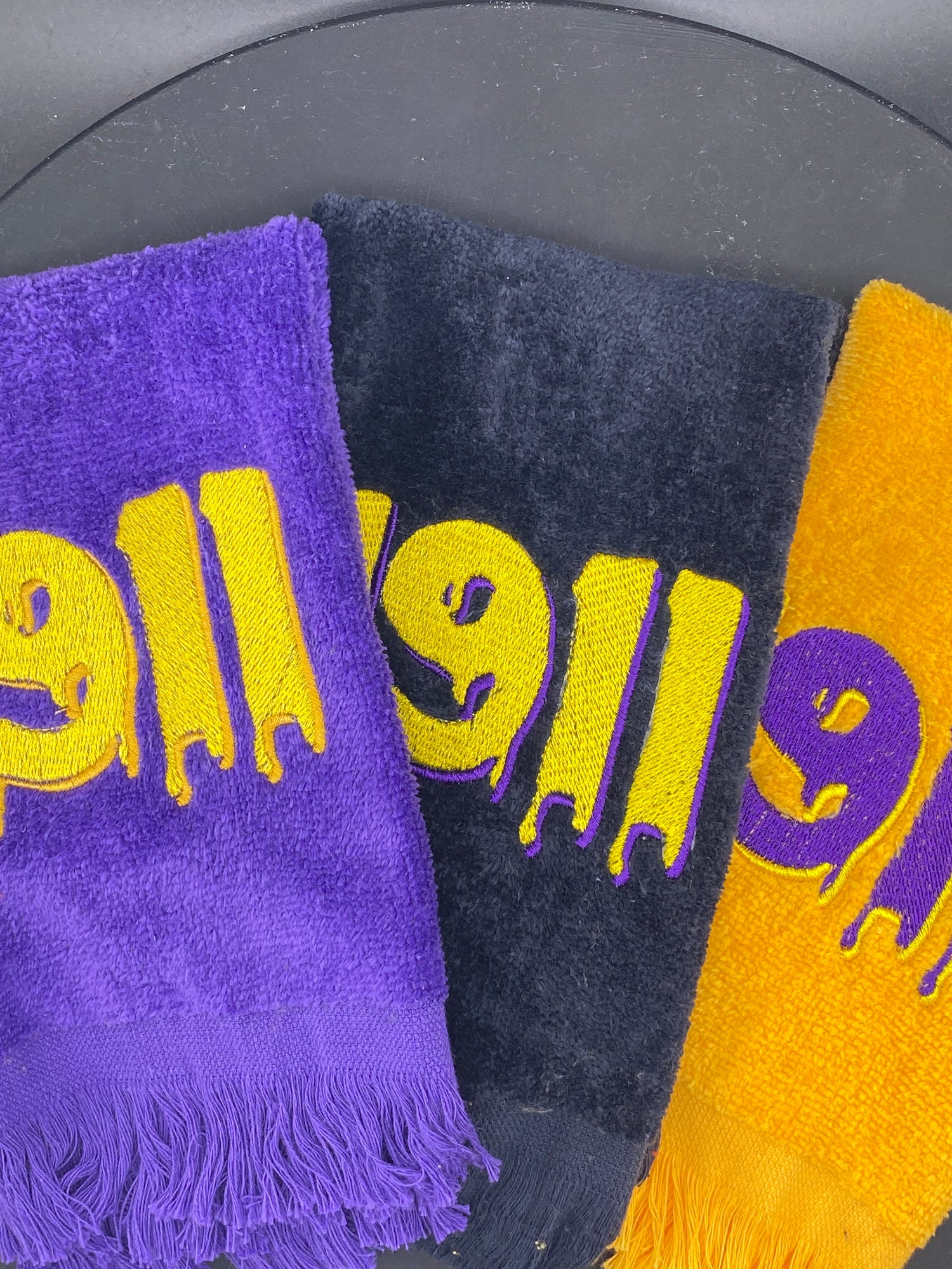 3 plush velour Hop Towels embroidered with 1911 on Purple, Black and Gold.