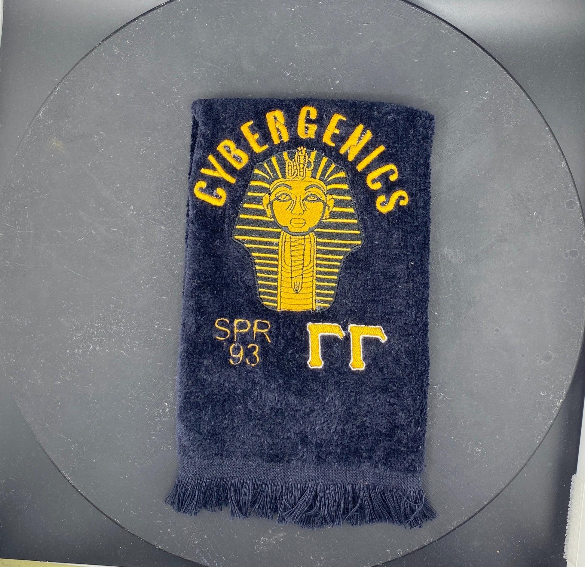 Custom Alpha Phi Alpha Sphinx Stroll towel with gold embroidery, featuring the Line name, fraternity’s symbol, and chapter on a black velour fingertip towel. Perfect for Greek events, strolls, and Divine 9 reunions.