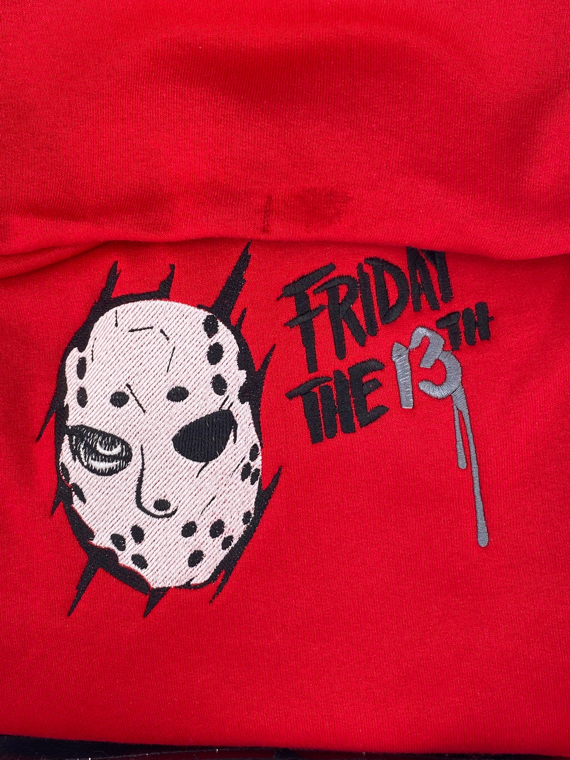 Red hoodie with a Jason Voorhees -inspired embroidery design and the text "Friday the 13th" in black and charcoal gray