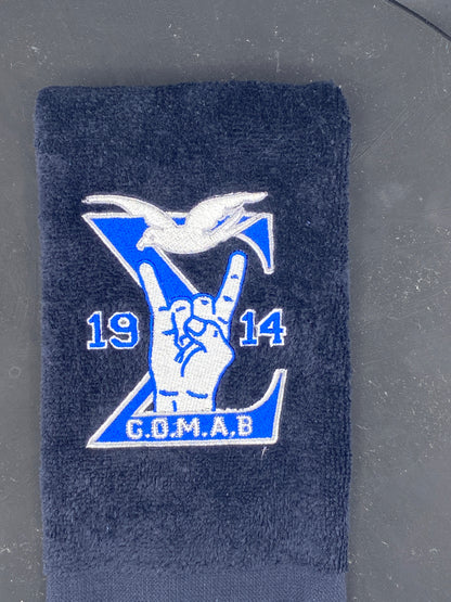 Black Stroll Towel with a Sigma, 1914, handsign, dove and GOMAB embroidered in royal blue, while and silver. 