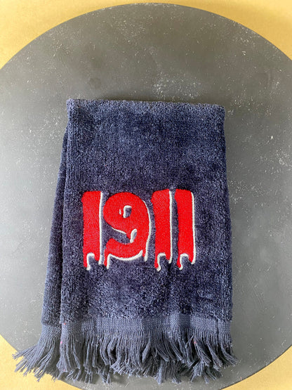 Black plush velour towel embroidered with a dripping 1911 in Red with white accent. 