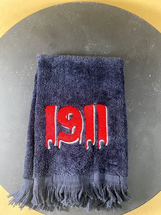 Black plush velour towel embroidered with a dripping 1911 in Red with white accent. 