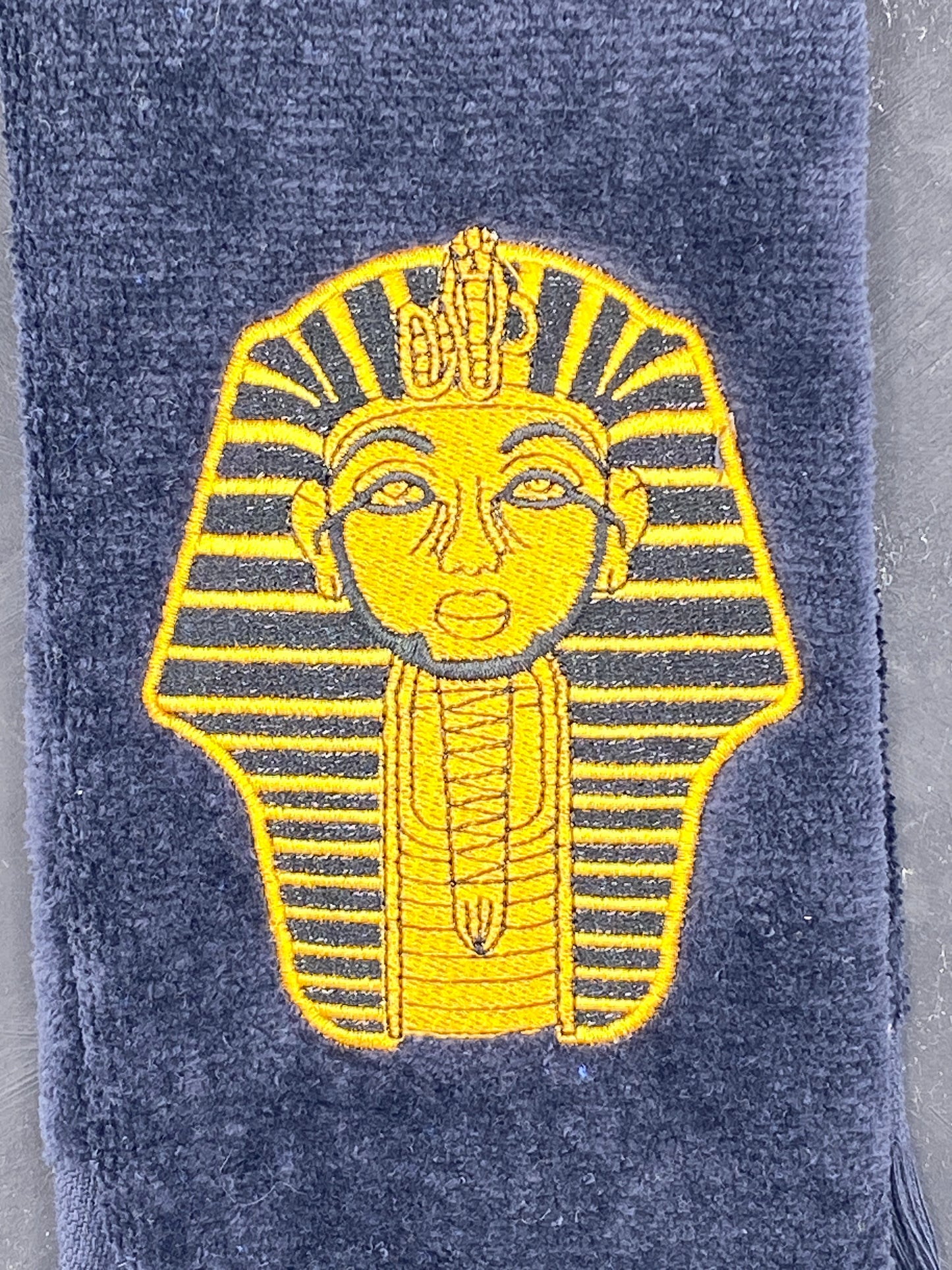 Old Gold Sphinx on black Alpha Phi Alpha Stroll Towel closeup detailed stitching. 