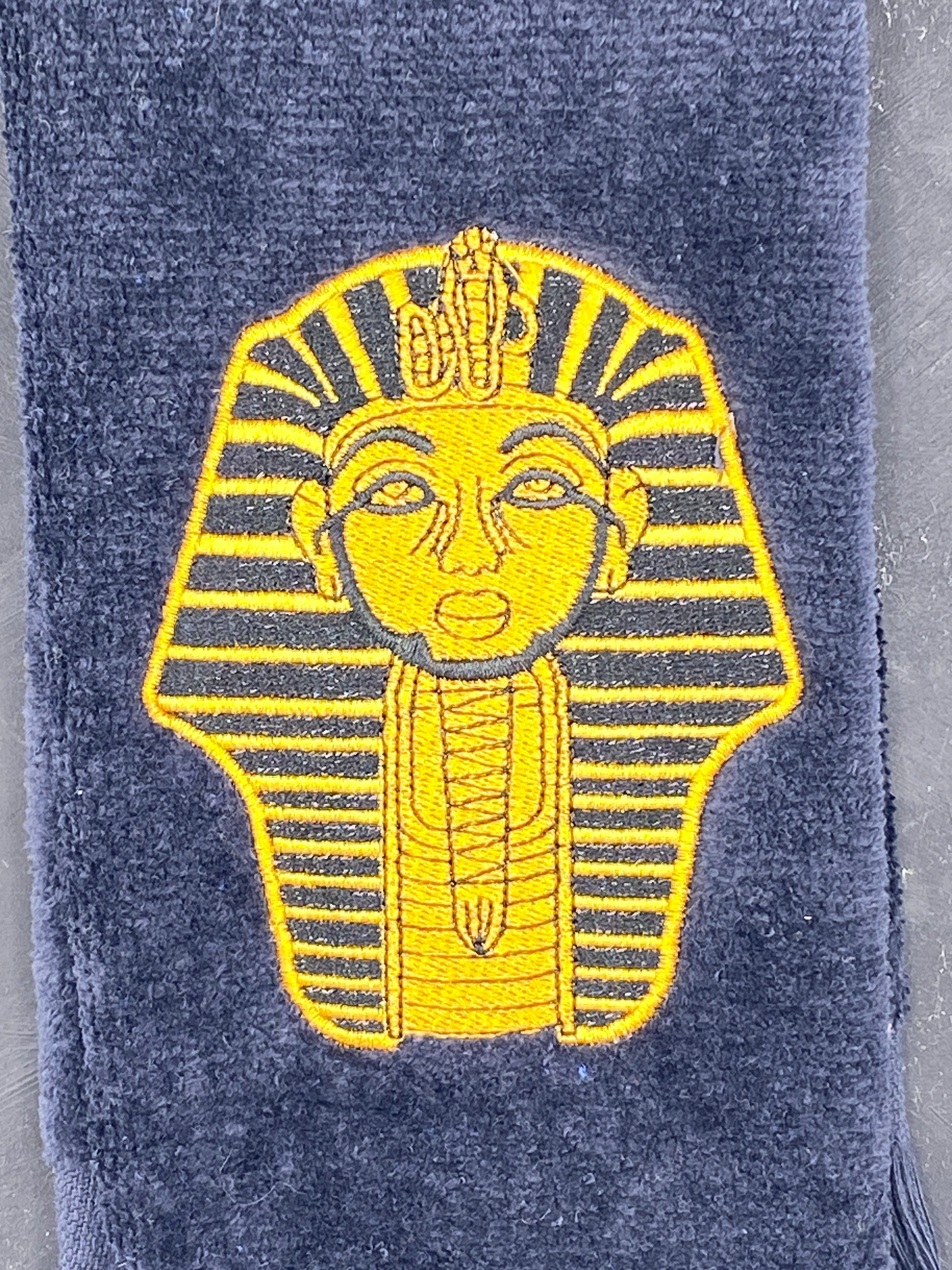 Old Gold Sphinx on black Alpha Phi Alpha Stroll Towel closeup detailed stitching. 