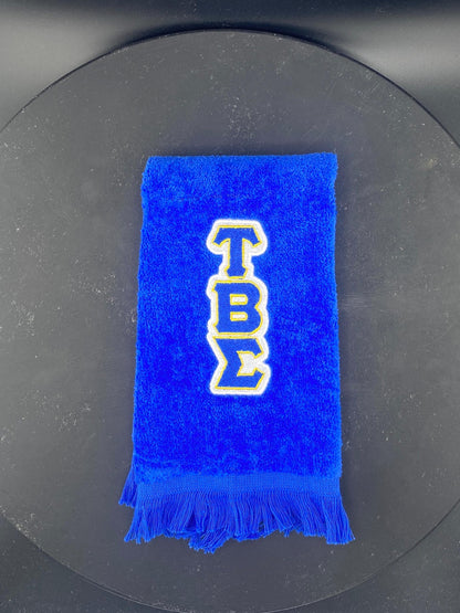 Tau Beta Sigma embroidered in white, royal blue and gold on a royal blue Leisure Luxe Towel.  