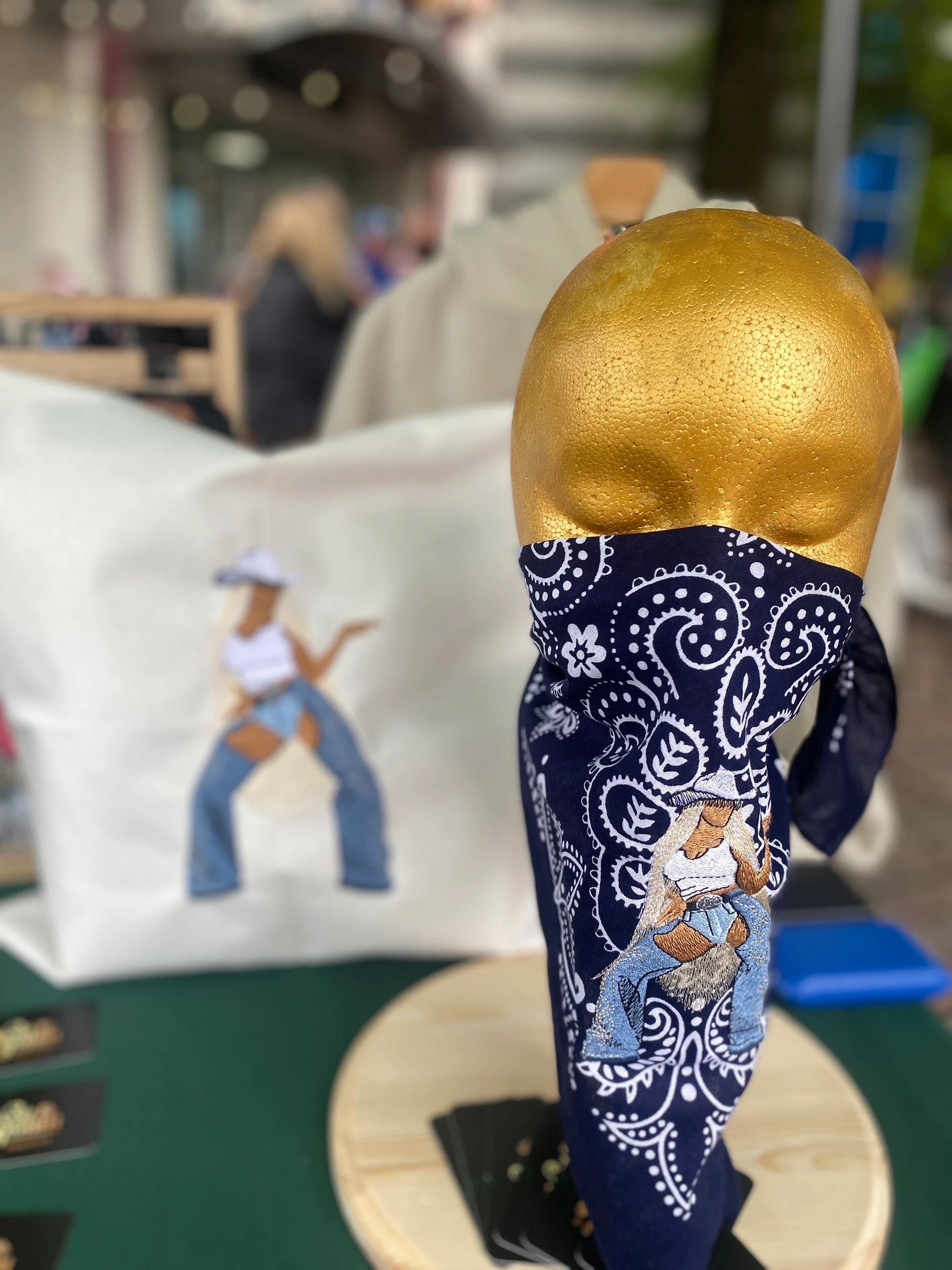 West & Remount Custom Apparel vending table setup with Cowboy Bey Pillow and Bandana.