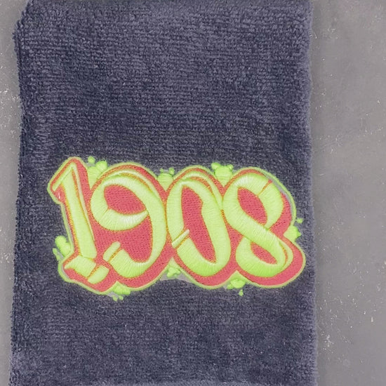 Glow detail of 1908 black velour leisure luxe towel.