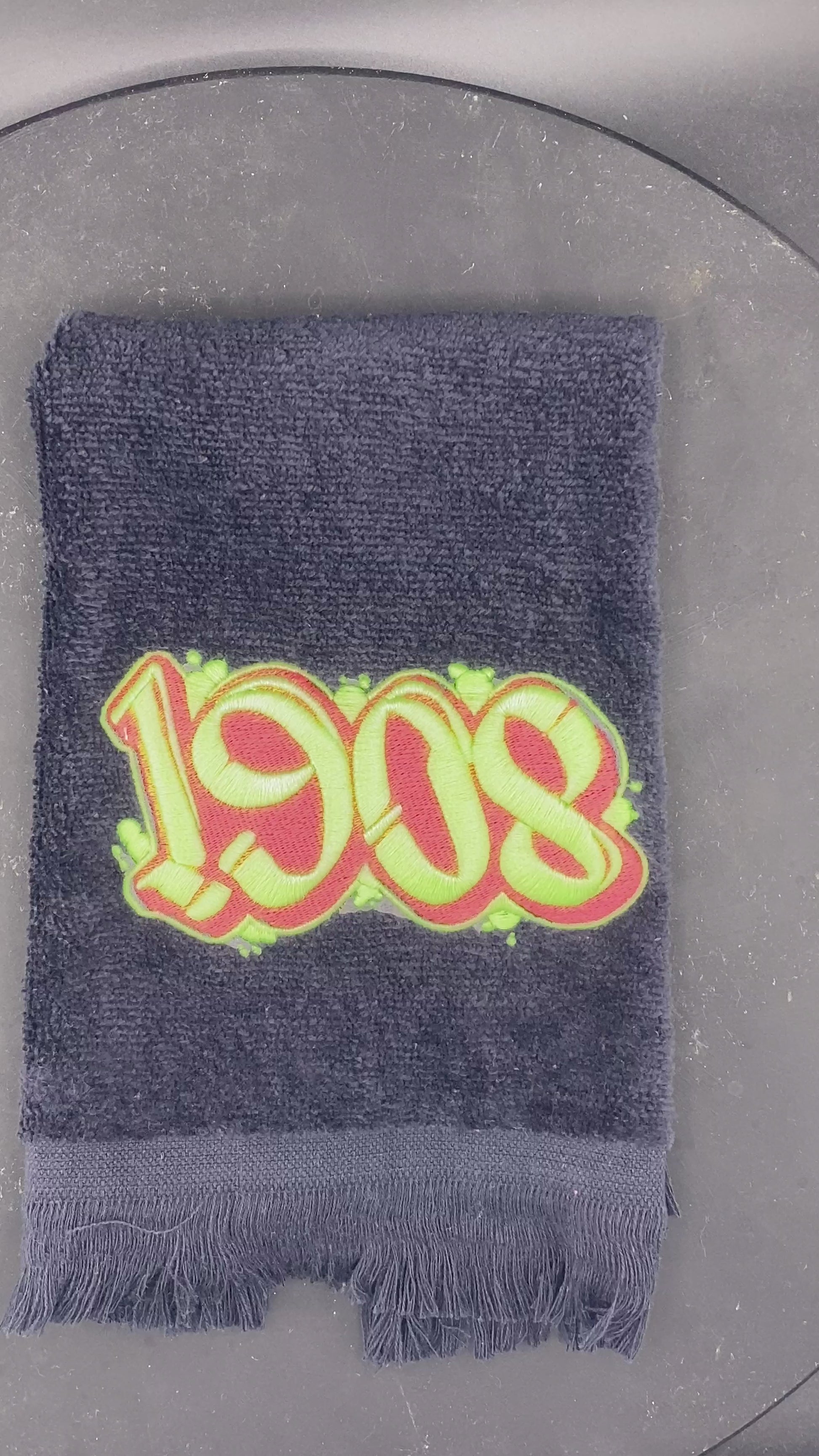 Glow detail of 1908 black velour leisure luxe towel.